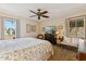 Cozy bedroom features neutral tones, ceiling fan, sitting area, and exterior view at 6717 E Aire Libre Ln, Scottsdale, AZ 85254