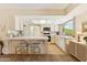 Cozy kitchen with white cabinets, a breakfast bar, modern appliances, and a well-lit space at 6717 E Aire Libre Ln, Scottsdale, AZ 85254
