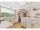 Bright kitchen featuring an island with tile countertops, white appliances, and a view to a dining area at 6717 E Aire Libre Ln, Scottsdale, AZ 85254