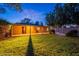 Relax in this backyard featuring manicured lawn, covered patio, and secure fencing at 7035 N 11Th Pl, Phoenix, AZ 85020