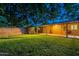 Enjoy the covered patio, lush lawn, and secure fencing of this private backyard at 7035 N 11Th Pl, Phoenix, AZ 85020