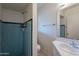 Traditional bathroom with blue tiled shower, white sink, and matching tiled floors at 7035 N 11Th Pl, Phoenix, AZ 85020