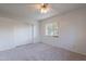 Carpeted bedroom featuring a ceiling fan, large window, and a closet with sliding doors at 7035 N 11Th Pl, Phoenix, AZ 85020