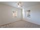 Carpeted bedroom featuring neutral walls, ceiling fan, and dual windows providing natural light at 7035 N 11Th Pl, Phoenix, AZ 85020