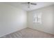 Bright bedroom featuring neutral carpet and paint, plus a window with blinds for natural light at 7035 N 11Th Pl, Phoenix, AZ 85020