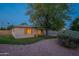 Quaint home with a well-kept lawn and mature tree providing shade and character to the property at 7035 N 11Th Pl, Phoenix, AZ 85020