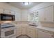 Functional kitchen with white appliances, tile counters, and ample storage space at 7035 N 11Th Pl, Phoenix, AZ 85020