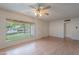 Bright living room with wood floors, large windows, and a classic ceiling fan at 7035 N 11Th Pl, Phoenix, AZ 85020