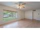 Bright living room with wood floors, large windows, and a classic ceiling fan at 7035 N 11Th Pl, Phoenix, AZ 85020