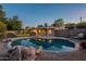 Private pool features rock accents and a safety fence for added peace of mind at 7035 N 11Th Pl, Phoenix, AZ 85020