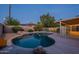 Tranquil backyard with pool, rock features, and a fenced-in area for relaxation and privacy at 7035 N 11Th Pl, Phoenix, AZ 85020