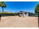 Backyard with rock landscape, shrubs, a gray house, and a privacy fence at 7343 E Juanita Ave, Mesa, AZ 85209