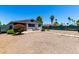The backyard features rock landscaping, privacy fencing, two chairs, and beautiful flowering bushes at 7343 E Juanita Ave, Mesa, AZ 85209