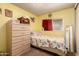 Comfortable bedroom with neutral walls, a cozy bed, dresser, and window at 7343 E Juanita Ave, Mesa, AZ 85209