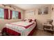Inviting bedroom featuring a comfortable bed with decorative pillows and natural light from the window at 7343 E Juanita Ave, Mesa, AZ 85209