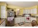 Cozy kitchen featuring white cabinets, tile flooring, and essential appliances for convenient cooking at 7343 E Juanita Ave, Mesa, AZ 85209
