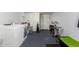 Spacious laundry room equipped with washer, dryer, storage units, and exercise equipment at 7343 E Juanita Ave, Mesa, AZ 85209