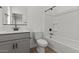 Well-lit bathroom with a modern vanity, toilet, and shower/tub combination with tile surround at 7427 S 75Th Ln, Laveen, AZ 85339