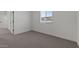 Bright bedroom with a window offering natural light and plush neutral carpeting at 7427 S 75Th Ln, Laveen, AZ 85339
