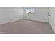 Bright bedroom with a window offering natural light and plush neutral carpeting at 7427 S 75Th Ln, Laveen, AZ 85339