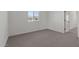 Bright bedroom with a window offering natural light and plush neutral carpeting at 7427 S 75Th Ln, Laveen, AZ 85339