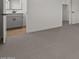 Bedroom area with neutral carpet flooring leading to an ensuite bathroom and closet space at 7427 S 75Th Ln, Laveen, AZ 85339