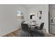 Dining area featuring a round table, four chairs, hardwood floors, and natural light at 7427 S 75Th Ln, Laveen, AZ 85339