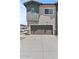 Exterior view of a two-car garage with neutral paint and a concrete driveway at 7427 S 75Th Ln, Laveen, AZ 85339