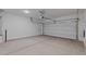 Spacious two-car garage with white walls and concrete floors at 7427 S 75Th Ln, Laveen, AZ 85339