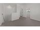 Upstairs hallway with neutral carpet and white walls leads to the bedroom and other rooms at 7427 S 75Th Ln, Laveen, AZ 85339