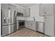 Bright kitchen with stainless steel appliances, light gray cabinets, and tile backsplash at 7427 S 75Th Ln, Laveen, AZ 85339