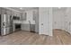 Bright kitchen with stainless steel appliances, light gray cabinets, and hardwood floors at 7427 S 75Th Ln, Laveen, AZ 85339