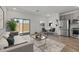 Modern living room with hardwood floors, neutral paint, and stainless steel appliances at 7427 S 75Th Ln, Laveen, AZ 85339