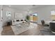 Cozy living room with hardwood floors, neutral paint, and natural light from a sliding glass door at 7427 S 75Th Ln, Laveen, AZ 85339