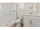 This bathroom features a glass shower, wood-style floors, and a white vanity at 7428 S 75Th Ln, Laveen, AZ 85339