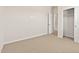 Neutral carpeted bedroom featuring a closet with sliding doors and a hallway entrance at 7428 S 75Th Ln, Laveen, AZ 85339