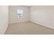 Bright bedroom features neutral carpet, white walls, and a window for natural light at 7428 S 75Th Ln, Laveen, AZ 85339
