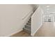 Bright hallway with wood-look tile floors and a carpeted staircase leading to the upper level at 7428 S 75Th Ln, Laveen, AZ 85339
