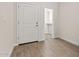 Hallway with tiled floors leading to a walk-in closet and a white door at 7428 S 75Th Ln, Laveen, AZ 85339