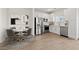Bright eat-in kitchen featuring stainless steel appliances and white cabinetry at 7428 S 75Th Ln, Laveen, AZ 85339