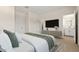 Stylish bedroom with a large bed, neutral decor, and a view into the en-suite bathroom at 7428 S 75Th Ln, Laveen, AZ 85339