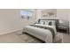 Bedroom features a large bed, stylish decor, and natural light from the window at 7428 S 75Th Ln, Laveen, AZ 85339