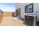 This exterior patio features a gravel ground cover, air conditioner, and sliding glass door at 7428 S 75Th Ln, Laveen, AZ 85339