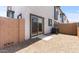 This view of the patio includes a sliding glass door and a gravel ground cover at 7428 S 75Th Ln, Laveen, AZ 85339