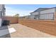 This gravel patio includes a view of the home's architecture and landscaping at 7428 S 75Th Ln, Laveen, AZ 85339