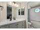 Bright bathroom features a tile floor, vanity and updated fixtures at 7716 S Rita Ln, Tempe, AZ 85284