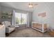 Charming Bedroom with crib, rocking chair, and natural light at 7716 S Rita Ln, Tempe, AZ 85284