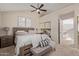 Serene bedroom with ceiling fan, calming decor, neutral color palette, and ample closet space at 7716 S Rita Ln, Tempe, AZ 85284