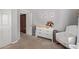 Bedroom featuring a changing table, chair, and ample storage space at 7716 S Rita Ln, Tempe, AZ 85284