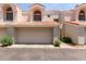 Inviting home exterior featuring a two-car garage, desert landscaping, and a unique tile roof at 7716 S Rita Ln, Tempe, AZ 85284
